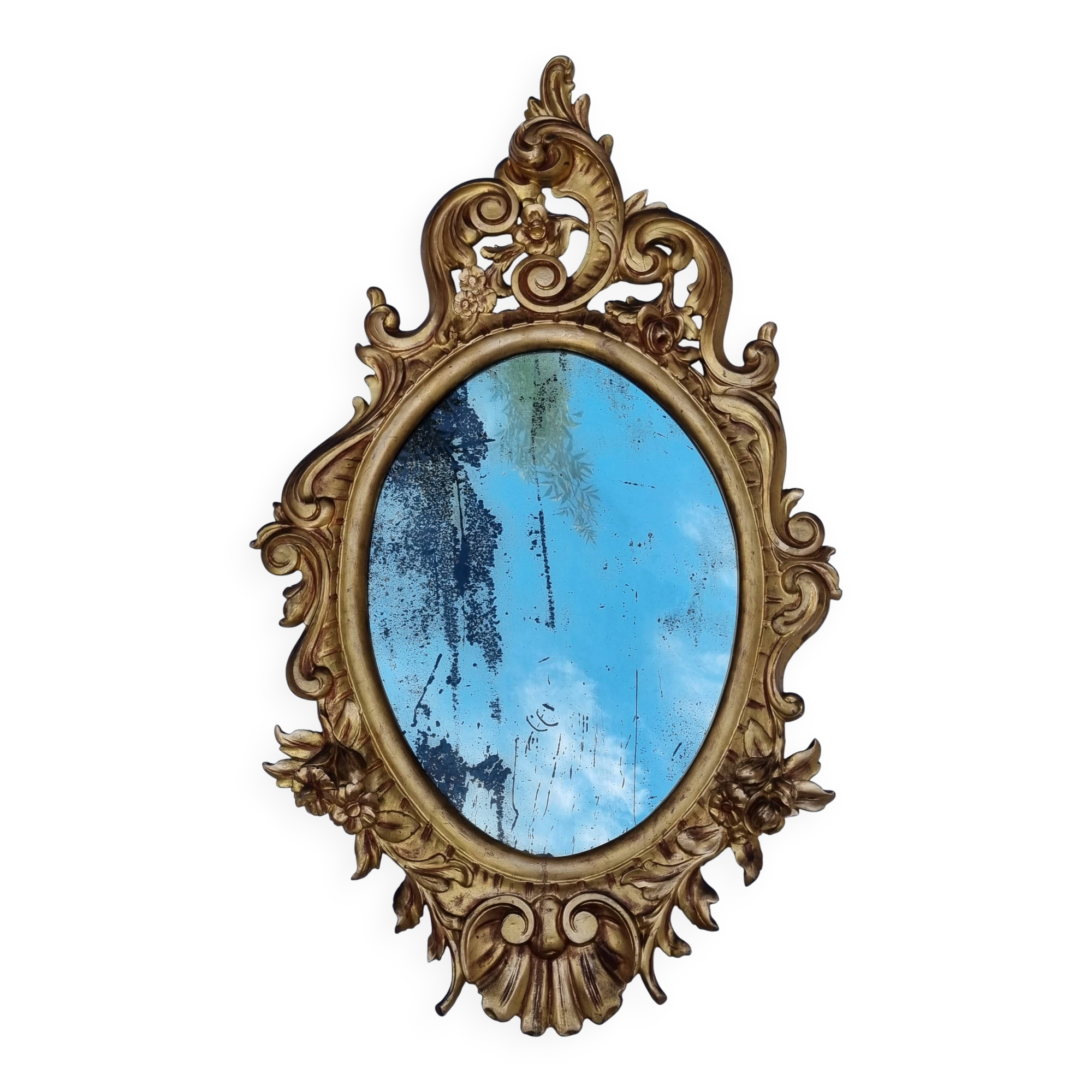 Large oval gold mirror, Louis XV rococo style, late 19th century, 114 x 66 cm.