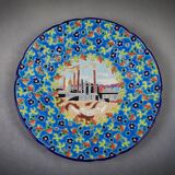 Longwy plate with polychrome enamels, decorated with the "City of Iron" motif.