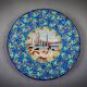Longwy plate with polychrome enamels, decorated with the "City of Iron" motif.