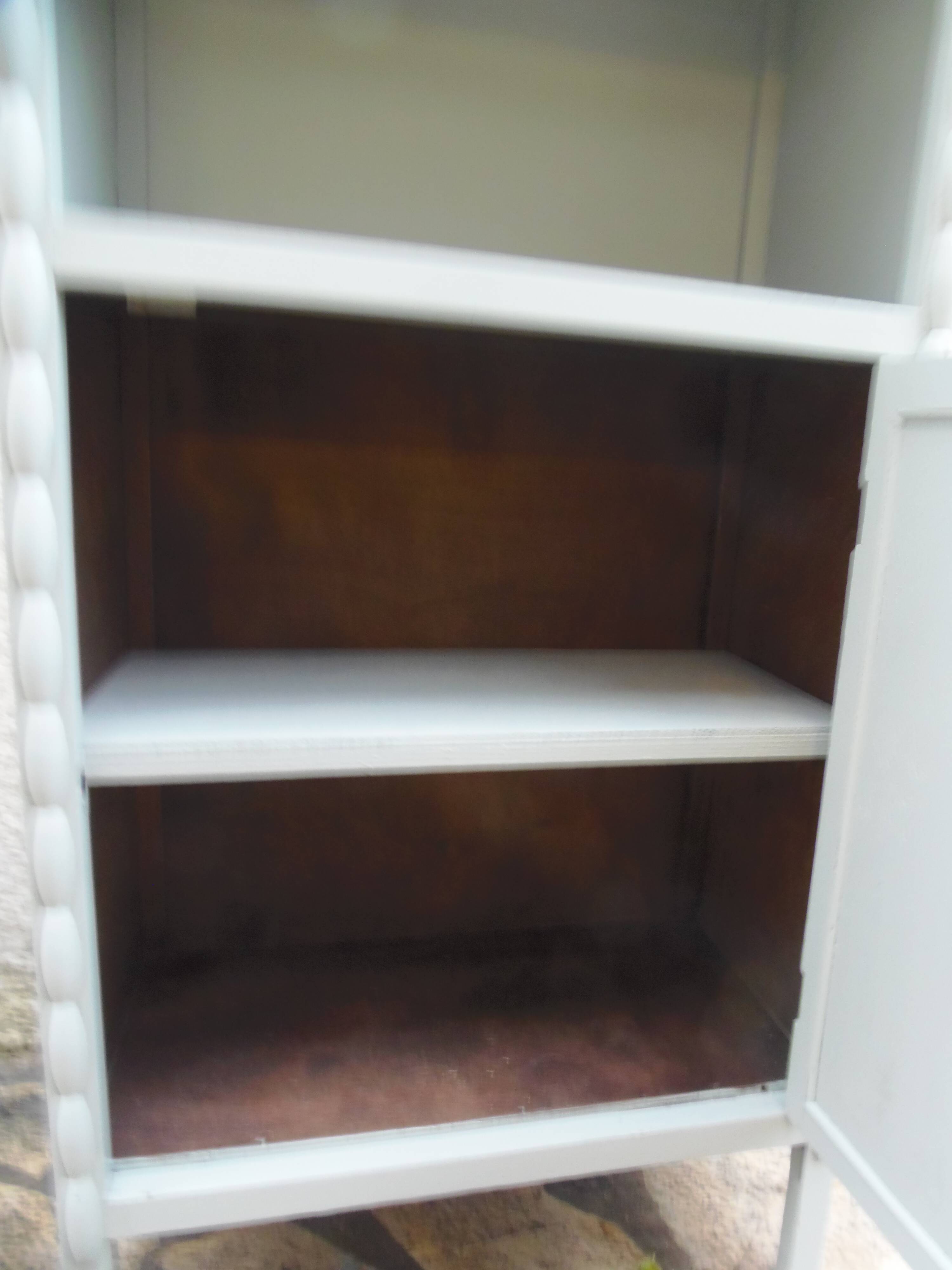 Vintage furniture of shallow depth re-enchanted in grey-green.