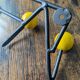 Vintage coat rack Roger Feraud with 4 yellow ball hooks.