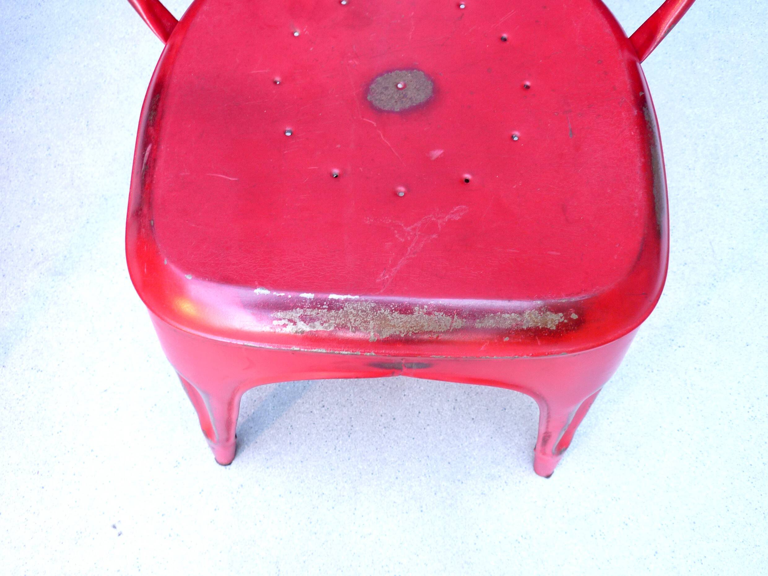 Pair of red stackable metal chairs