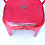 Pair of red stackable metal chairs