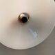 A set of hanging lamps in milky white opal glass with brass top.
