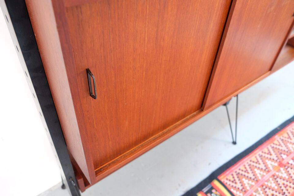 Vintage teak shelving system in 60s-70s style, retro style.
