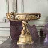 Alabaster bowl decorated with vine leaves on a base of three dolphins, circa 1880.