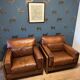 Ensemble de deux fauteuils en cuir de buffle.