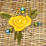 Vintage wicker mannequin with colourful floral decoration.