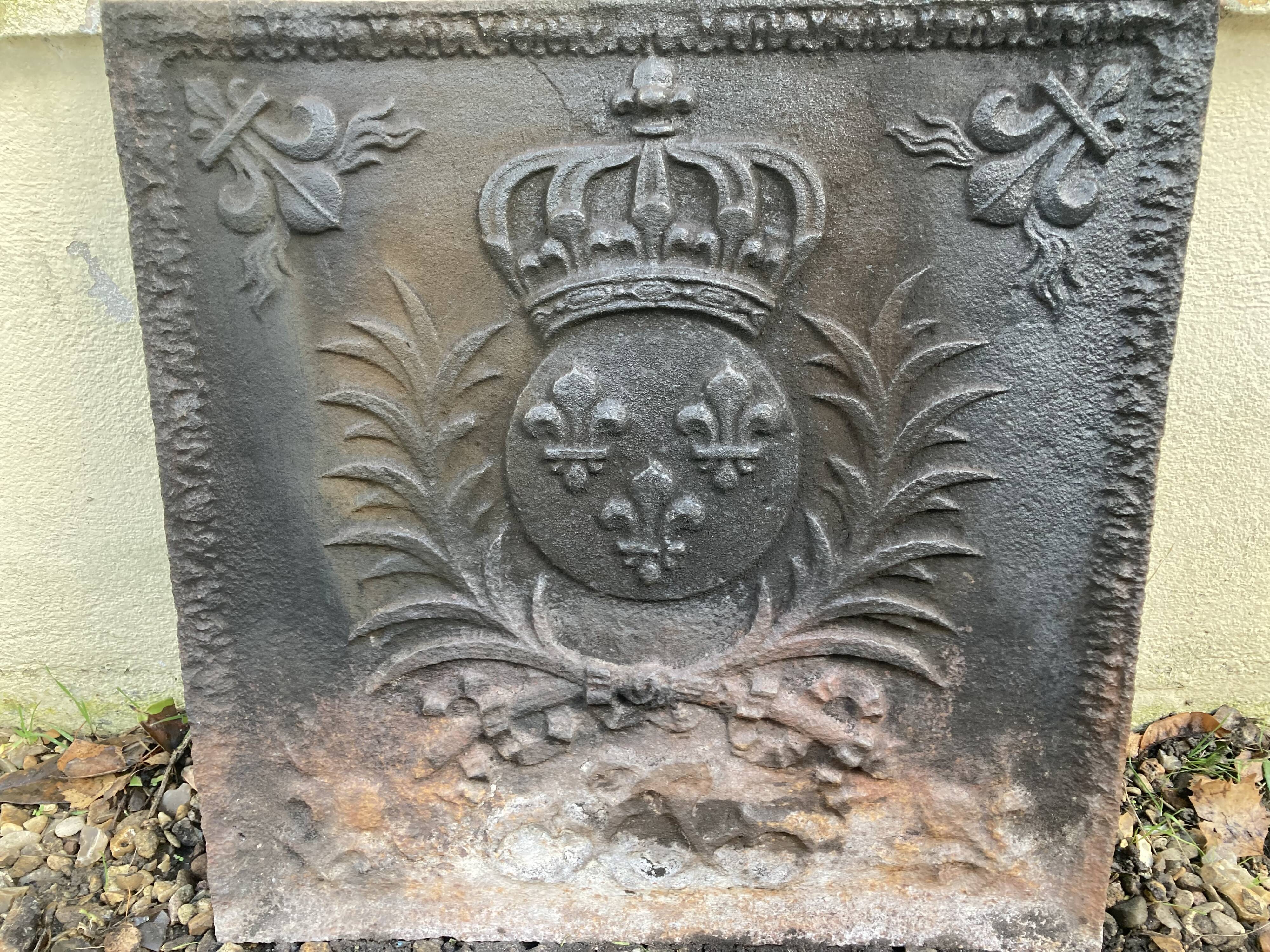 Old cast iron fireback with royal coat of arms
