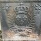 Old cast iron fireback with royal coat of arms