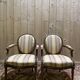 Paire de fauteuils médaillons de style Louis XVI