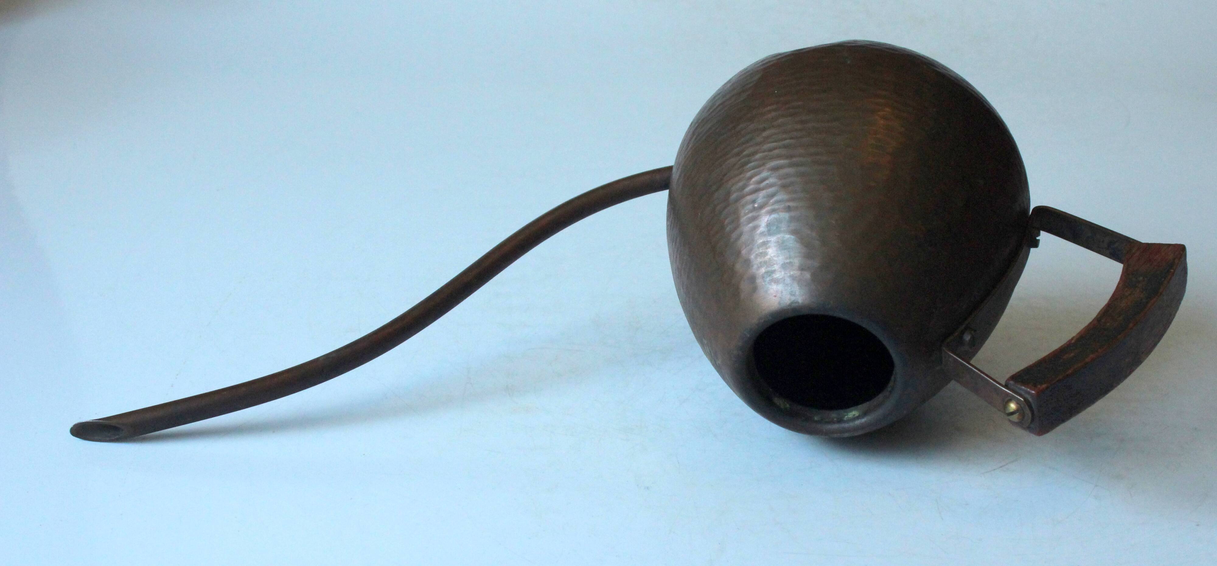 Old copper watering can with wooden handle, complete usuable, vintage from the 1960s