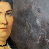 Old oil painting on canvas portrait of a woman with a red bow, late 19th century