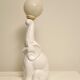 White ceramic table lamp, an elephant holding a lighted ball