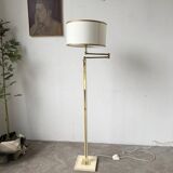 Floor lamp with articulated arm in brass-plated metal