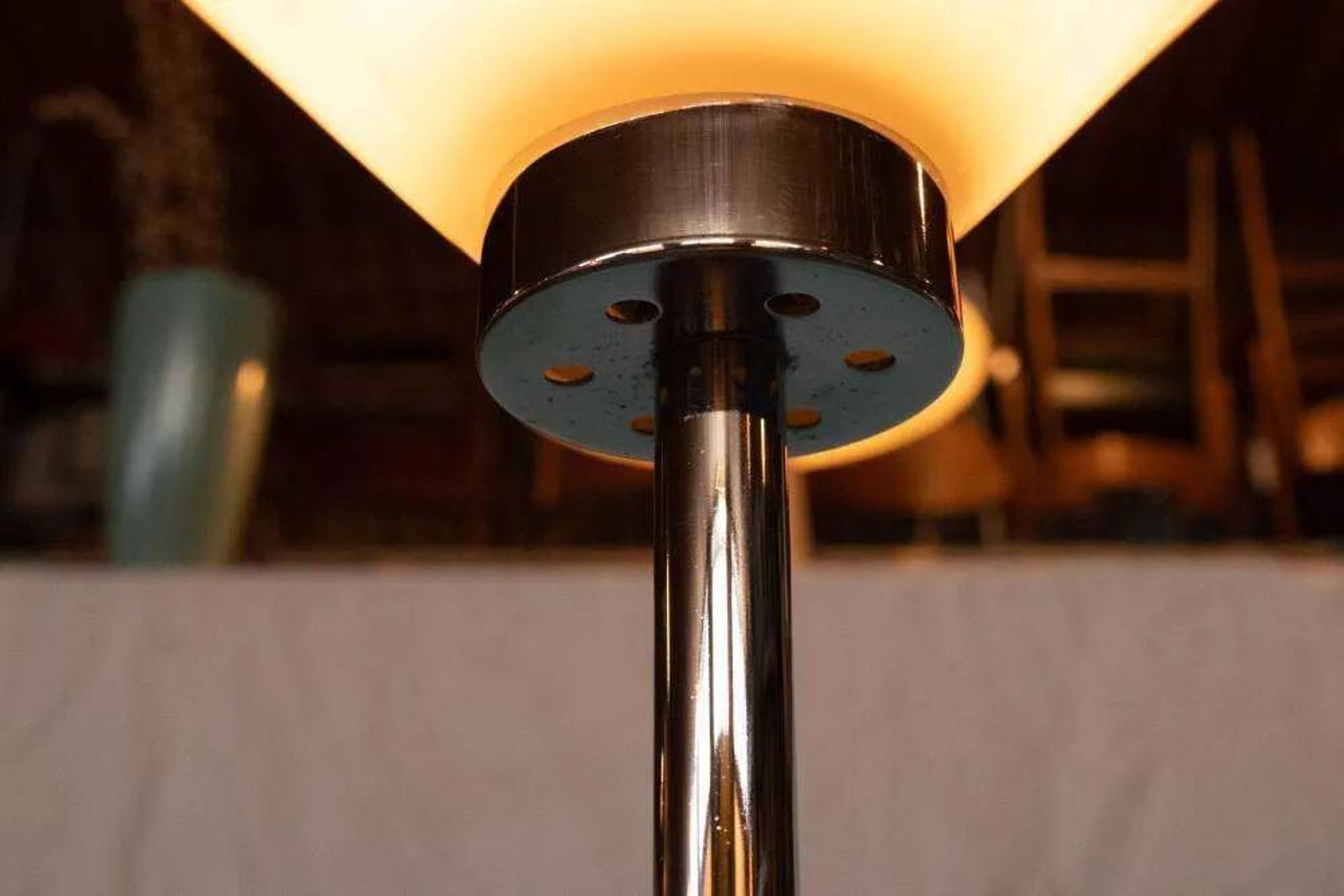 Vintage floor lamp in milky glass and chrome, minimalist uplight lighting.