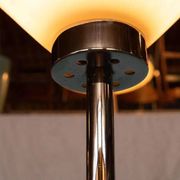 Vintage floor lamp in milky glass and chrome, minimalist uplight lighting.