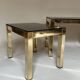 Set of three nesting side tables in brass and smoked mirror.