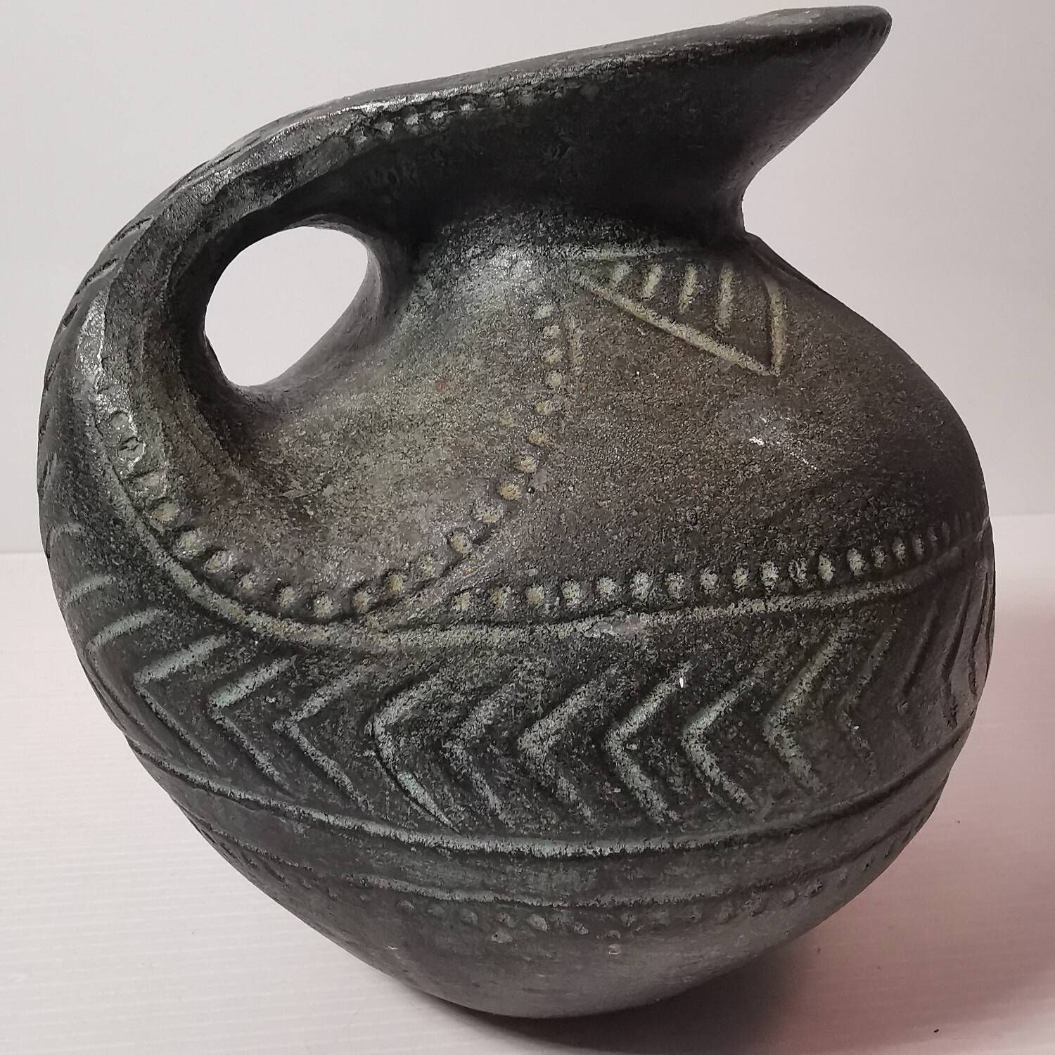 Vintage native american jug pot with geometric patterns in green / gray tones