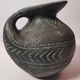 Vintage native american jug pot with geometric patterns in green / gray tones