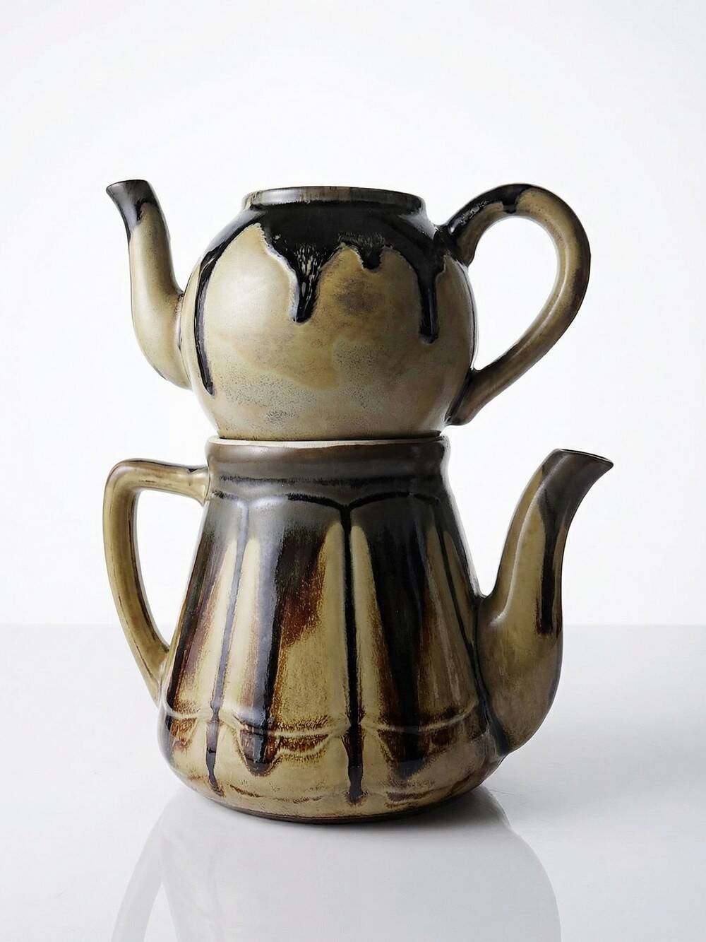 A pair of small vintage teapots in the Art Deco style reminiscent of Denbac.