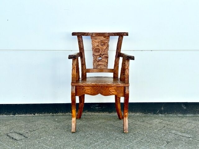 Hand stabbed teak armchair