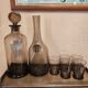 Table service set with a carafe, bottle, and 5 glass cups.