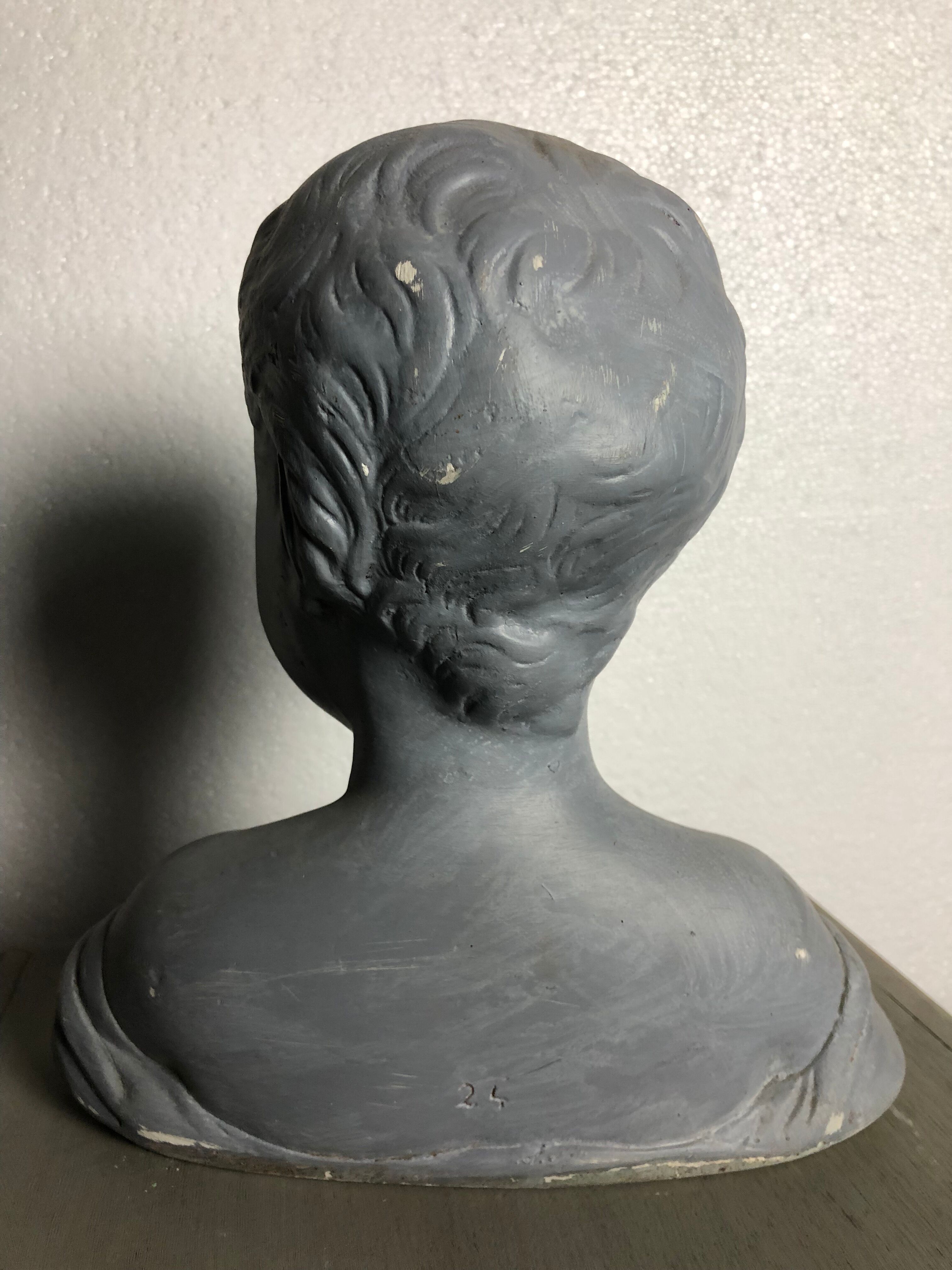 Child bust in grey patinated plaster