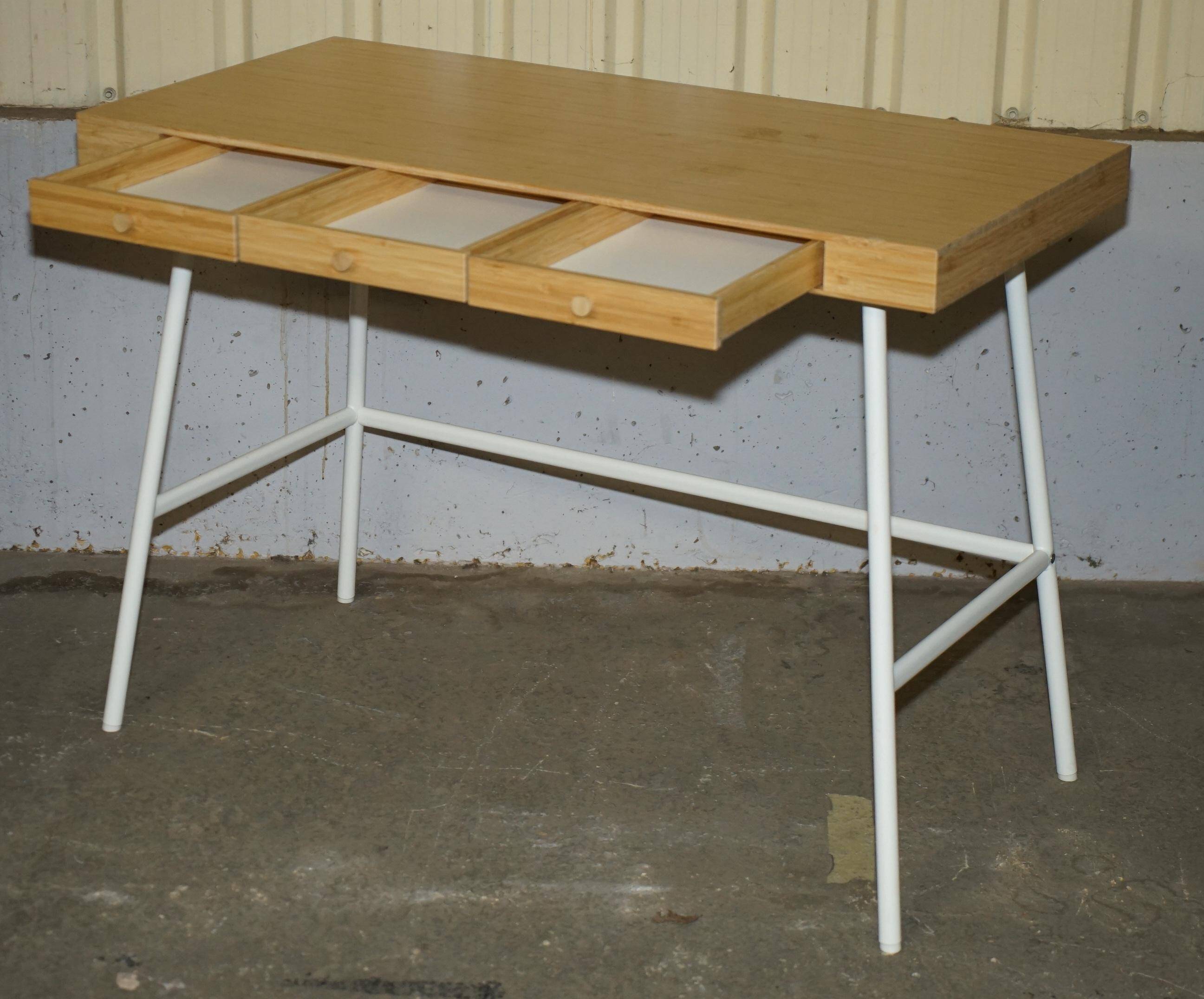 Small bamboo desk with three drawers.