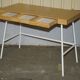 Small bamboo desk with three drawers.