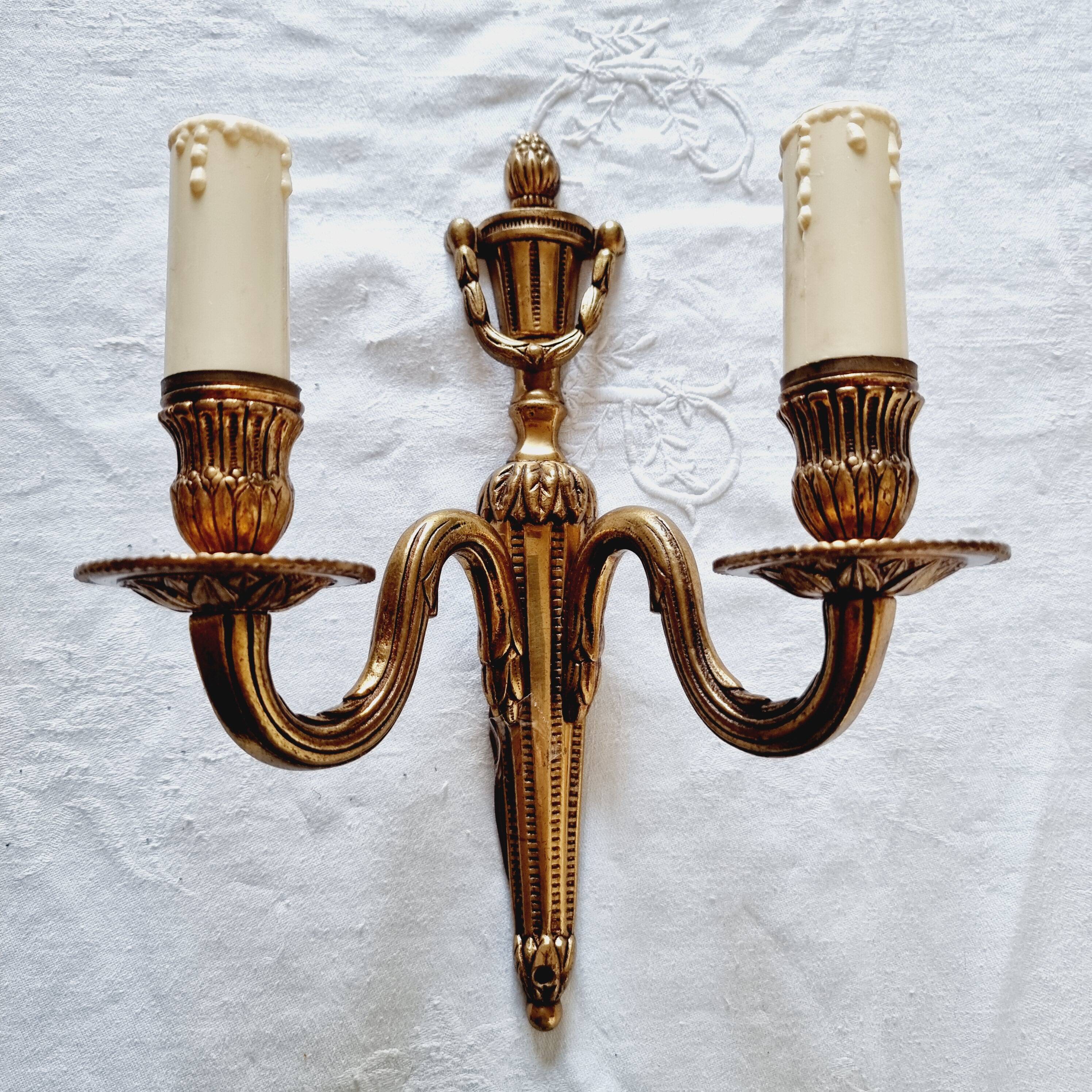 French Empire-style wall sconce or chandelier in bronze with an antique gold patina.
