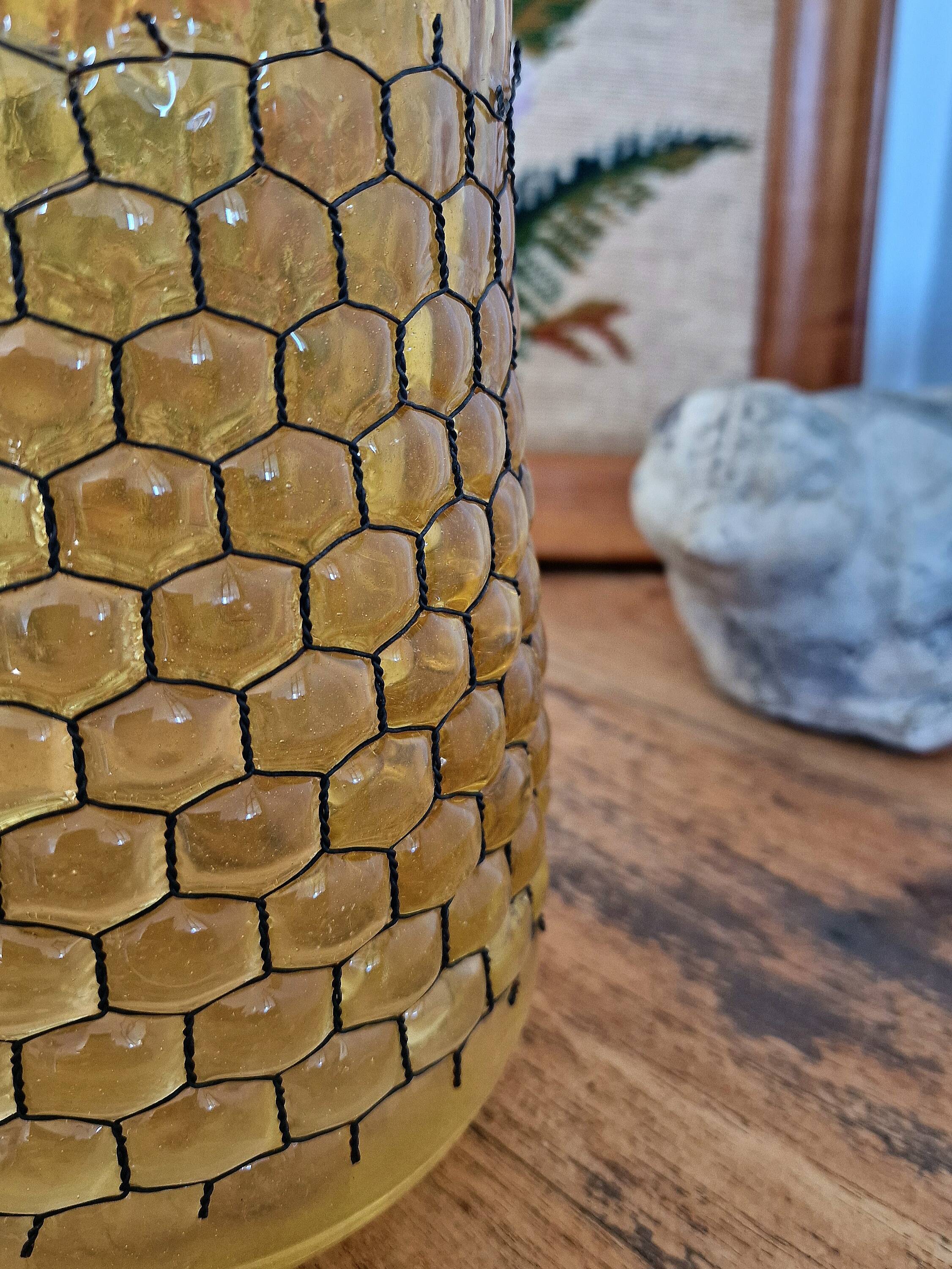 Artisanal blown amber glass vase with integrated honeycomb structure.