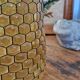 Artisanal blown amber glass vase with integrated honeycomb structure.