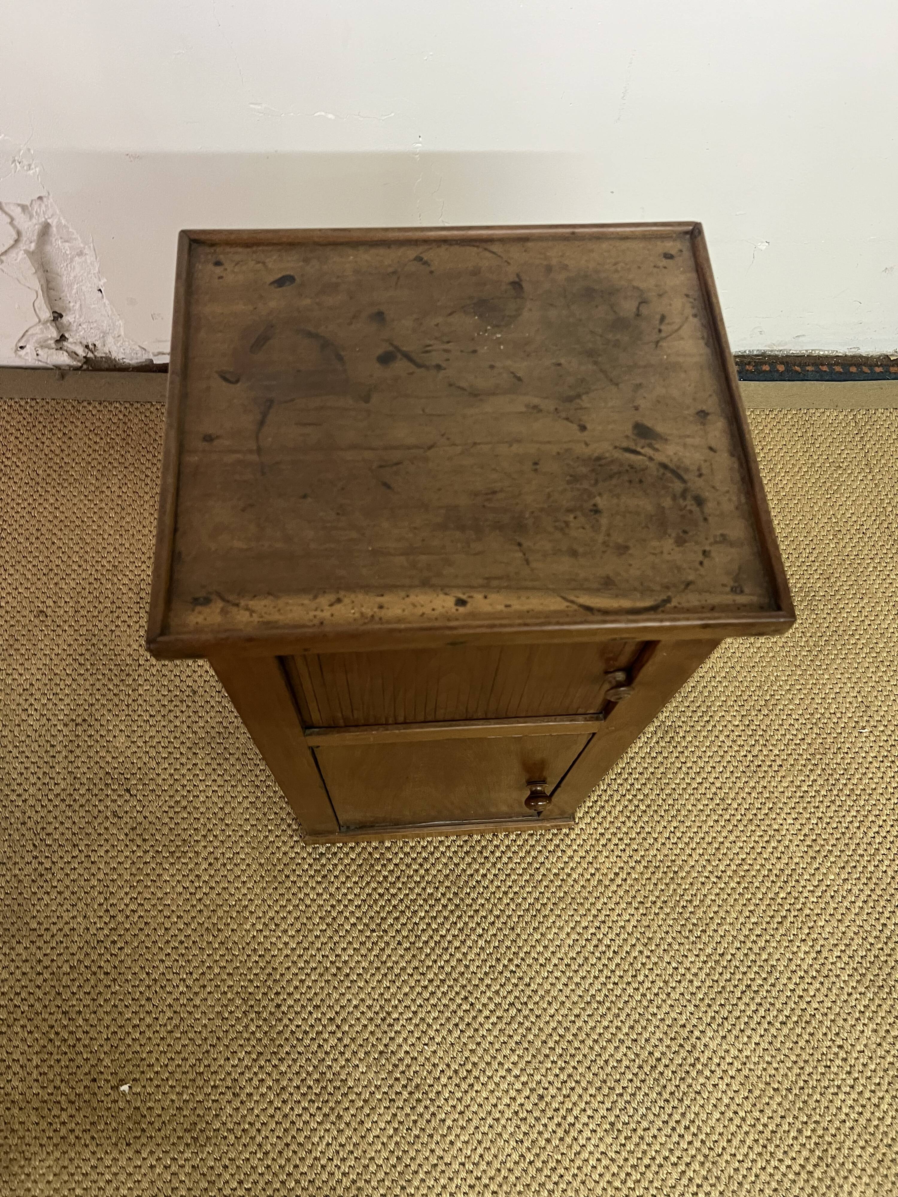 Old small storage unit with sliding and hinged doors.
