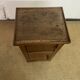 Old small storage unit with sliding and hinged doors.