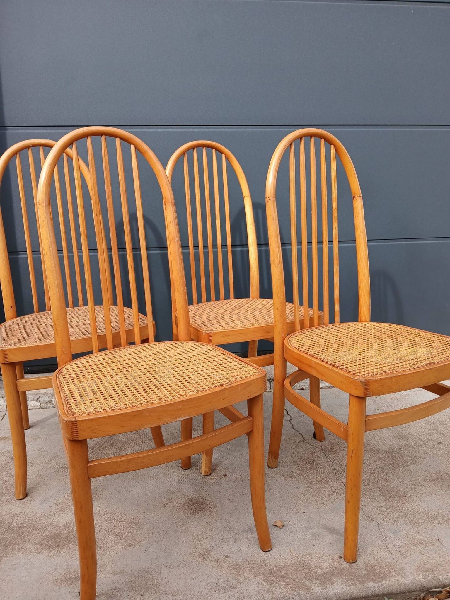 Set of 4 vintage Baumann chairs in honey wood and cane.