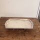 Art Deco metal plate, silvered, hammered on a flat vintage serving stand.