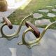 Pair of Art Nouveau coat hooks in bronze and chestnut, circa 1930.