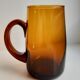 Ensemble composé d’un pichet et de 6 verres ambrés années 70
