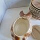 Many flat plates, dish, sauce boat, vegetable dish.