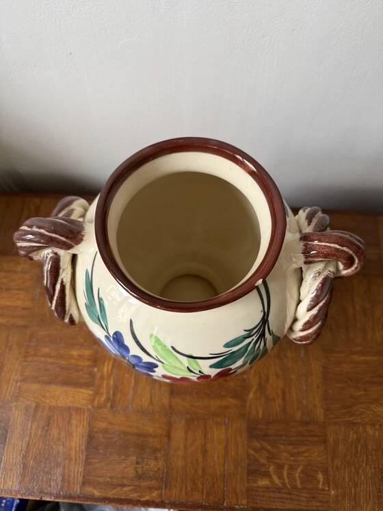 Ceramic vase with hand-painted floral decoration.