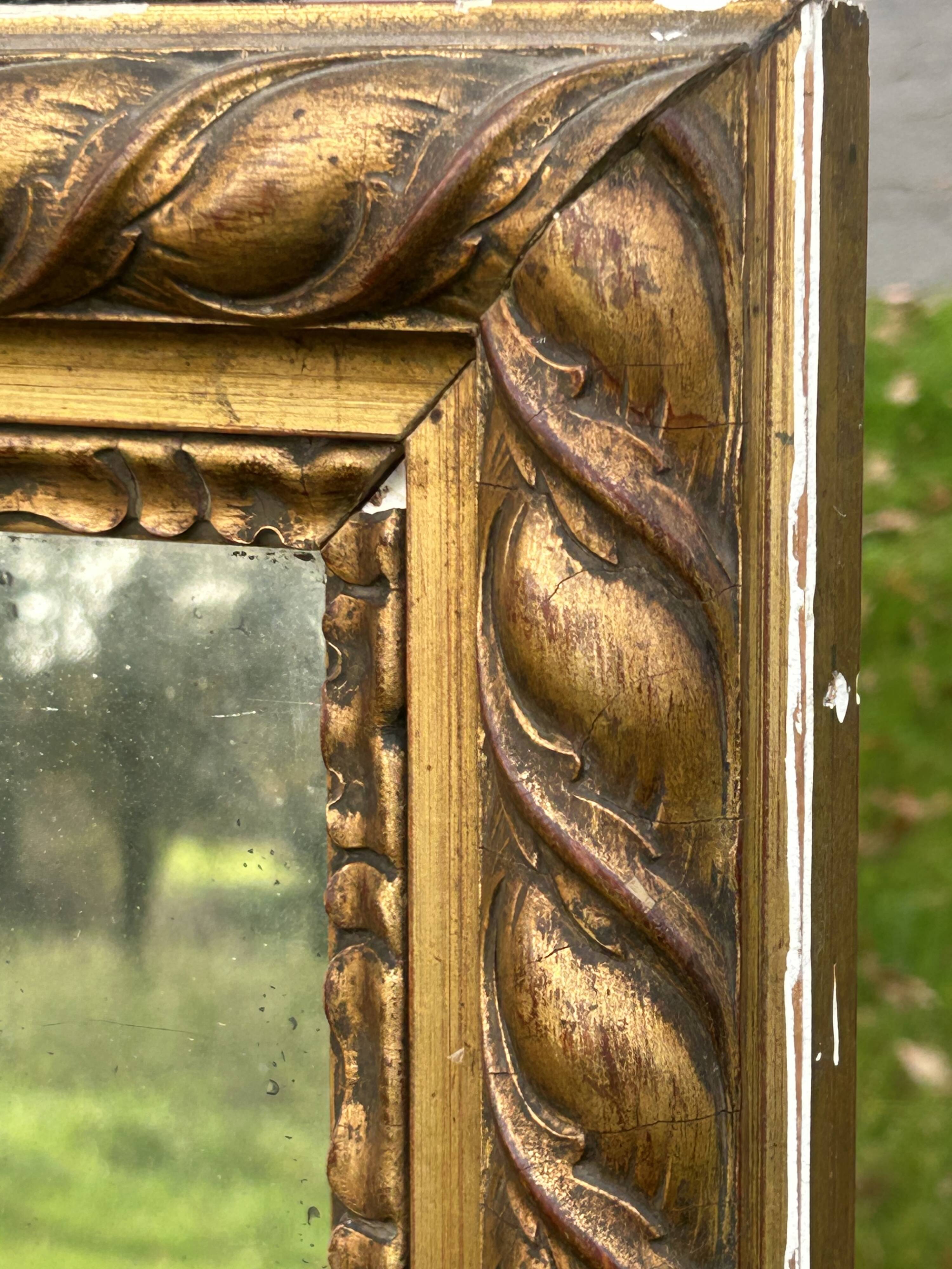Large antique gilded mirror, wood and stucco gadroons, partially de-mercury
