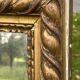 Large antique gilded mirror, wood and stucco gadroons, partially de-mercury
