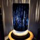 Table lamp in black stoneware and natural raffia.