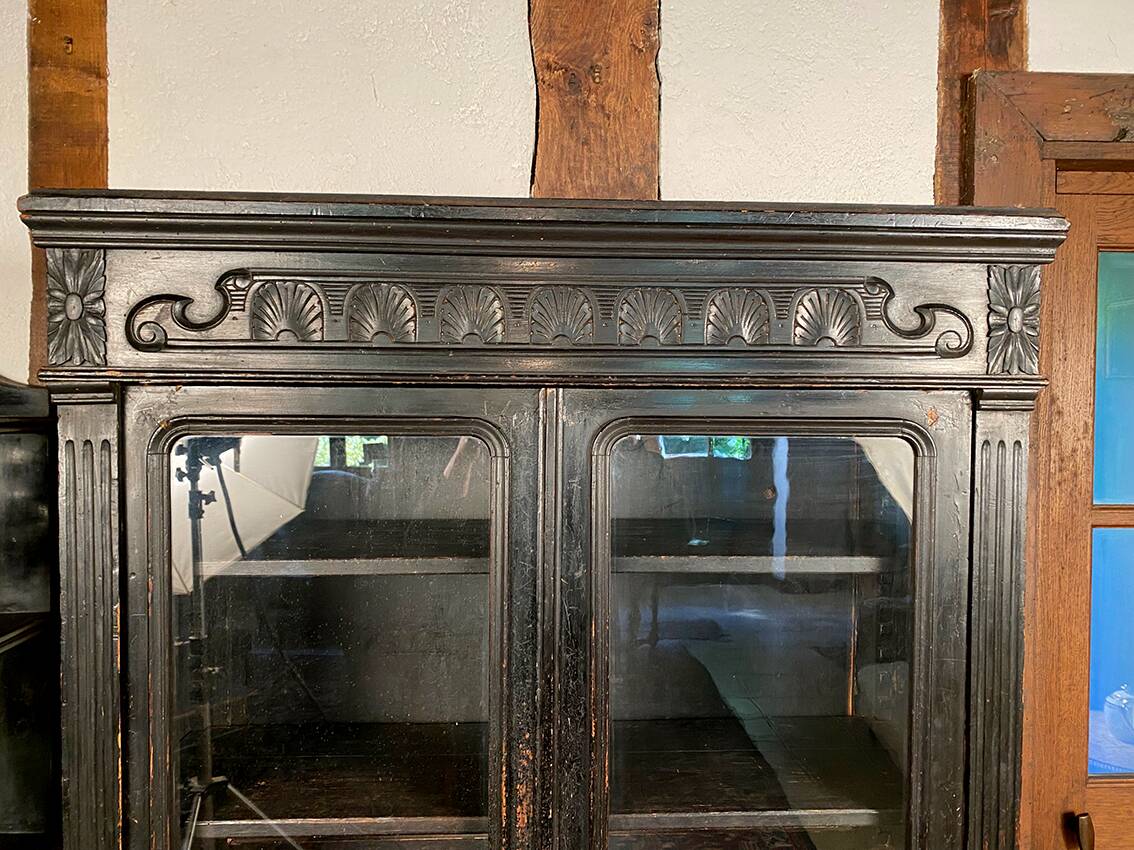 Blackened wooden display cabinet from the late 19th or early 20th century.