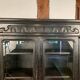 Blackened wooden display cabinet from the late 19th or early 20th century.