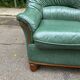 Vintage 2-seater sofa in green leather and solid wood