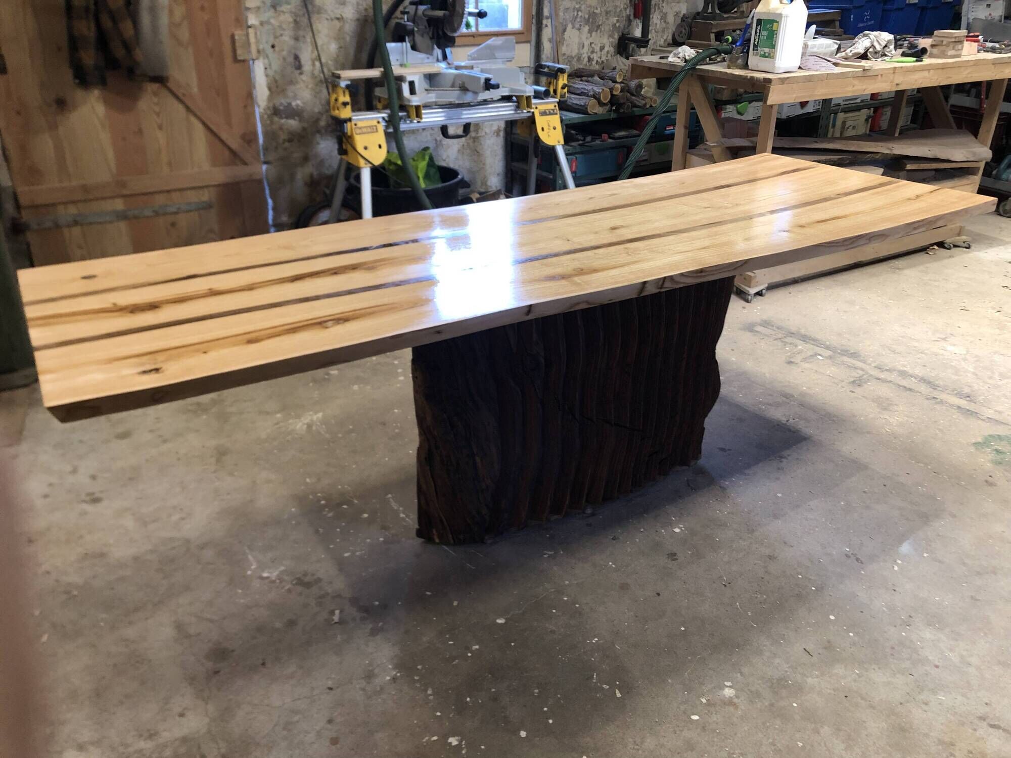 Chestnut and walnut solid table and benches with a central leg.