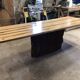 Chestnut and walnut solid table and benches with a central leg.