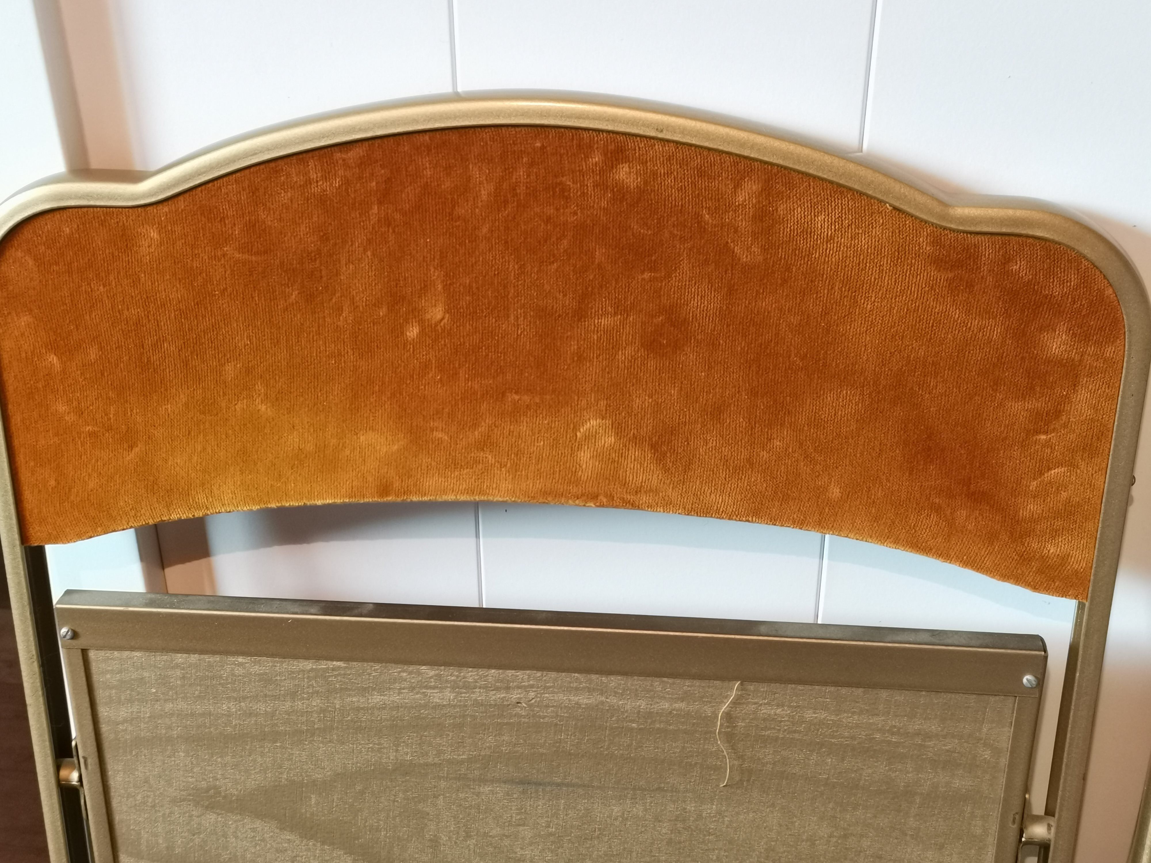 Two gold velvet folding chairs